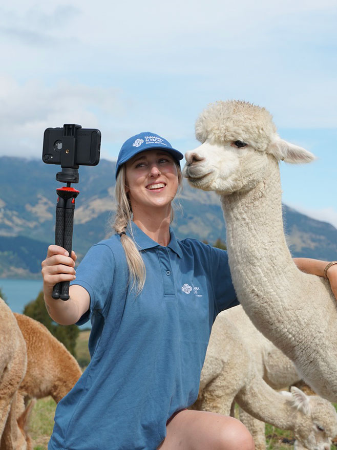 Lydia taking a selfie with an alpaca